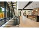 Bright open floorplan features modern staircase, light wood floors, and kitchen with barstool seating at 1601 S Columbine St, Denver, CO 80210