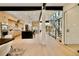 Open floorplan features modern staircase, light wood floors, and kitchen with black marble island at 1601 S Columbine St, Denver, CO 80210