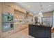 Contemporary kitchen with light wood cabinets, a dark island, and stainless steel appliances at 1601 S Columbine St, Denver, CO 80210