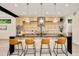 Modern kitchen with sleek island, stylish bar stools, pendant lighting, and light wood cabinets at 1601 S Columbine St, Denver, CO 80210