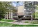 Front entrance of the building with steps and landscaping at 6940 E Girard Ave # 203, Denver, CO 80224