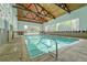 Indoor swimming pool with a high ceiling and wooden beams at 6940 E Girard Ave # 203, Denver, CO 80224