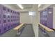 Row of purple lockers with wooden benches at 6940 E Girard Ave # 203, Denver, CO 80224