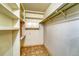 Large storage room with shelving and hanging rods at 6940 E Girard Ave # 203, Denver, CO 80224