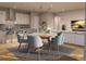 Open concept dining area with stylish chandelier and adjacent to the kitchen and living room at 1929 Grayside Cir, Castle Rock, CO 80109