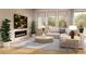 Bright living room with modern fireplace, large windows, and comfortable seating area at 1929 Grayside Cir, Castle Rock, CO 80109