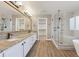 Modern bathroom with double vanity and a large walk-in shower at 15008 Clayton St, Thornton, CO 80602