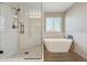 Bathroom with a soaking tub and walk-in shower at 15008 Clayton St, Thornton, CO 80602