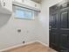 Laundry room with white cabinets and vinyl flooring at 15008 Clayton St, Thornton, CO 80602