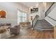 Virtually staged living room features hardwood floors and a high ceiling at 15008 Clayton St, Thornton, CO 80602