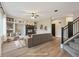 Virtually staged living room with a fireplace and built-in shelving at 15008 Clayton St, Thornton, CO 80602