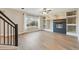 Living room with fireplace, built-ins, hardwood floors and lots of light at 15008 Clayton St, Thornton, CO 80602