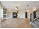 Living room with built-in shelving, fireplace, and hardwood floors at 15008 Clayton St, Thornton, CO 80602