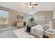 Virtually staged main bedroom with large windows and ceiling fan at 15008 Clayton St, Thornton, CO 80602