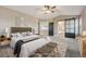 Virtually staged main bedroom with high ceilings and a ceiling fan at 15008 Clayton St, Thornton, CO 80602