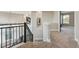 Upper hallway with carpet, neutral walls, and a view to the lower level at 15008 Clayton St, Thornton, CO 80602