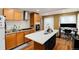 Modern kitchen with island, stainless steel appliances, and hardwood floors at 2610 S Vine St, Denver, CO 80210