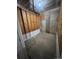 A view of the unfinished basement shows walls with framed plywood, concrete, and painted baseboards at 5335 Pecos Way # 4, Denver, CO 80221