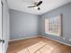 Spacious bedroom featuring hardwood floors, a ceiling fan, and a window dressed with light pink curtains at 5335 Pecos Way # 4, Denver, CO 80221