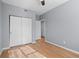 Light-filled bedroom with hardwood floors, a ceiling fan, closet and door into hall at 5335 Pecos Way # 4, Denver, CO 80221