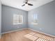 Bright bedroom with hardwood floors, light gray walls, and natural light from two windows at 5335 Pecos Way # 4, Denver, CO 80221
