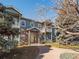 The building's front exterior shows balconies, green siding, brick accents, and nice landscaping at 5335 Pecos Way # 4, Denver, CO 80221