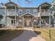 Charming two-story condo with balconies, brick accents, and well-maintained lawn at 5335 Pecos Way # 4, Denver, CO 80221