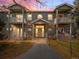 Charming two-story condo with balconies, brick accents, and well-maintained lawn at 5335 Pecos Way # 4, Denver, CO 80221