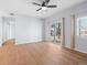 Bright living room with hardwood floors, ceiling fan, and sliding glass doors to balcony at 5335 Pecos Way # 4, Denver, CO 80221