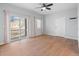 Living room featuring balcony access, hardwood floors, and a bright, open space at 5335 Pecos Way # 4, Denver, CO 80221