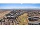 An aerial view of the neighborhood featuring the community golf course and mature trees at 14273 E Marina Dr, Aurora, CO 80014