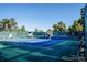 Community tennis court under a clear sky, surrounded by lush greenery at 14273 E Marina Dr, Aurora, CO 80014