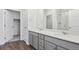 Elegant bathroom with dual sinks, quartz countertops, gray cabinetry and a glass-enclosed shower at 487 Interlocken Blvd # 408, Broomfield, CO 80021