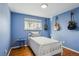 Bedroom with hardwood floors and blue walls, featuring decorative guitars at 3406 E Fair Pl, Centennial, CO 80121