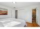 Bright bedroom with hardwood floors, closet, and attached bathroom entrance at 3406 E Fair Pl, Centennial, CO 80121