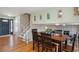 Open-concept dining area features hardwood floors, a staircase, and natural light, creating an inviting space at 3406 E Fair Pl, Centennial, CO 80121