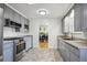 Well-lit kitchen features stainless steel appliances, gray cabinets, and tile flooring at 3406 E Fair Pl, Centennial, CO 80121
