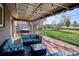 Cozy covered patio with outdoor seating, string lights, and a view of the landscaped backyard at 3406 E Fair Pl, Centennial, CO 80121