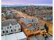 Stunning aerial view of neighborhood homes with the city skyline and mountains in the background during a beautiful sunrise at 566 Monroe St, Denver, CO 80206