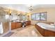 Luxurious bathroom featuring double vanities, a soaking tub, and a glass-enclosed shower at 566 Monroe St, Denver, CO 80206