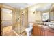 Well-lit bathroom with a glass-enclosed shower and marble countertops at 566 Monroe St, Denver, CO 80206