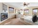 Bright bedroom with a fireplace, ceiling fan, and natural light from multiple windows at 566 Monroe St, Denver, CO 80206