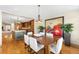 Open-concept dining room adjacent to the kitchen, boasting hardwood floors and an elegant chandelier at 566 Monroe St, Denver, CO 80206