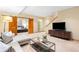 Living area with barn doors, a glass wine cellar, TV area, and plush furniture at 566 Monroe St, Denver, CO 80206