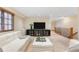 Spacious living room featuring a TV, fireplace, and staircase to a loft area at 566 Monroe St, Denver, CO 80206