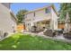 Well-maintained backyard with patio, outdoor dining set, and lush green lawn for relaxation at 1382 Braewood Ave, Highlands Ranch, CO 80129