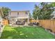 Spacious backyard featuring a patio with outdoor dining and lounging areas, and a well-maintained lawn at 1382 Braewood Ave, Highlands Ranch, CO 80129