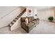 Finished basement features stairs, cozy seating, and lots of space at 1382 Braewood Ave, Highlands Ranch, CO 80129