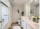 Bright bathroom featuring double sinks, vanity, tile flooring, and shower at 1382 Braewood Ave, Highlands Ranch, CO 80129