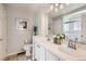 Bright bathroom featuring double sinks, vanity, tile flooring, and walk-in shower at 1382 Braewood Ave, Highlands Ranch, CO 80129